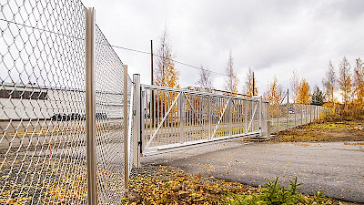 Sliding gate with chain link fencing protecting and demarcating Industrial estate.