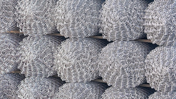 Useita panssariverkkoaitarullia pinottuna päällekkäin varastoon.